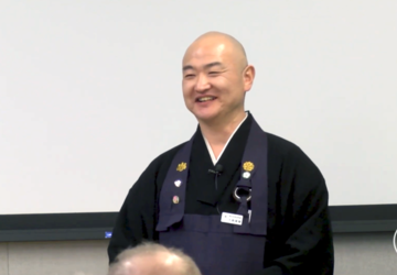 Reverend Shinyu Okuma speaking at Stanford
